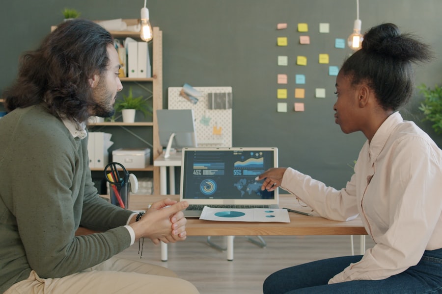 Dos personas analizando gráficos en la pantalla de un computador